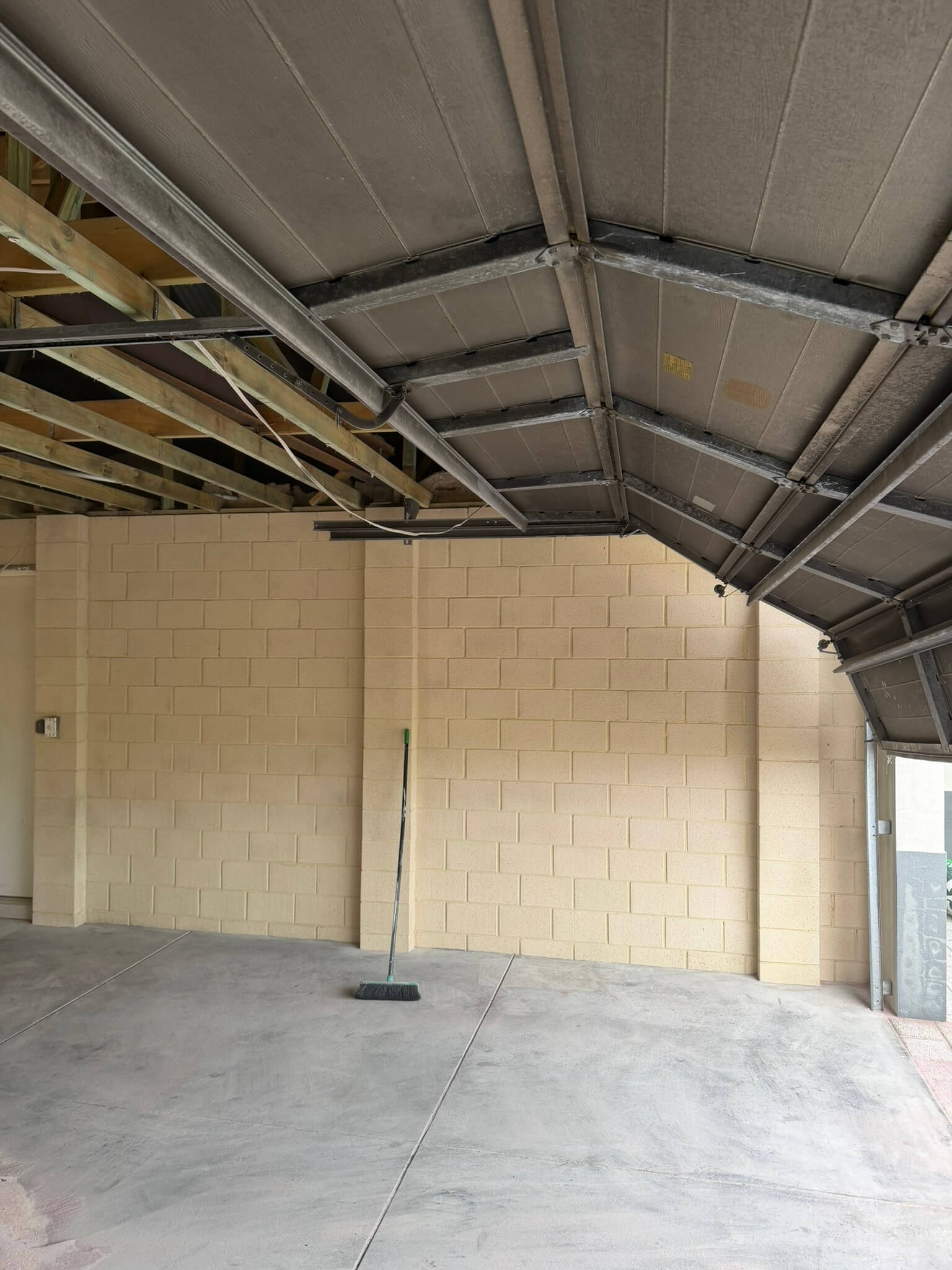 Soot and char removed The same garage with soot and char removed from the block walls, ceiling sheeting and roof steel