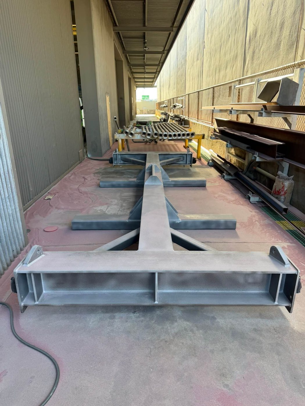 The same lifting beam blasted to a uniform grey profile with the lifting lugs left clean