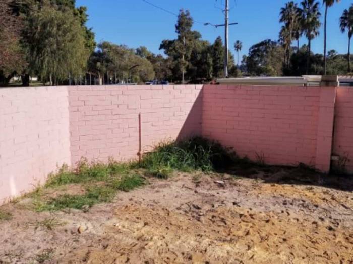 Pink painted brick boundary wall in Perth before blasting