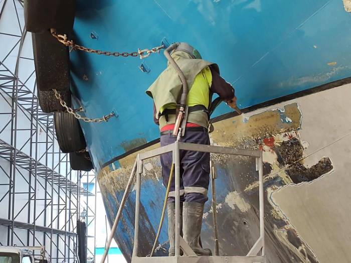 Blasting in action Wet abrasive blasting in action with the dust dropping at the nozzle
