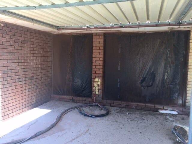 Red brick boundary fence restored after paint removal in Perth