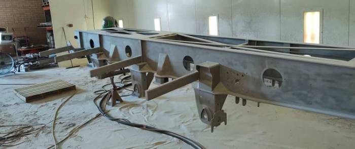 Truck cab panel blasted to remove layered paint without heat distortion
